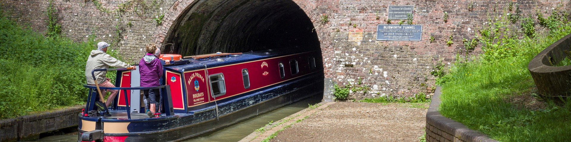 Narrowboat entering a canal tunnel